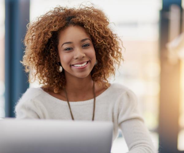 Portrait of a young businesswoman sitting at her laptop in an office