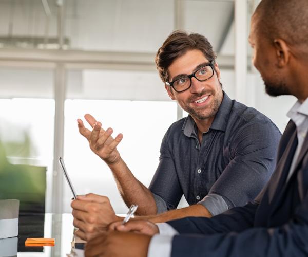 Two men discussing business at a table