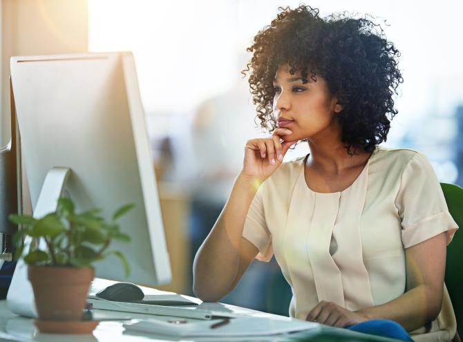 Designer working at her computer in an office