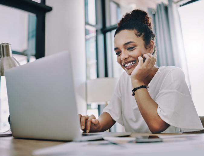 Businesswoman using a laptop while working in her home office